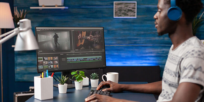 secure film production_virtual security A remote video editor reviews footage on his computer